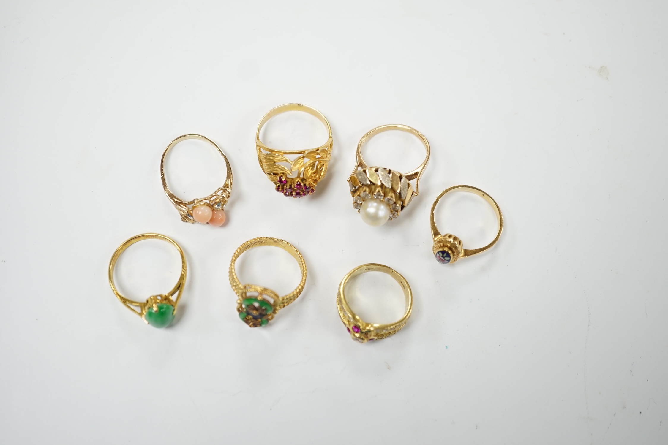 A Middle Eastern 750 yellow metal and two colour enamel up-finger ring, size M, a Chinese 750 yellow metal and gem set cluster ring, gross weight 9.4 grams, a 14k and jade set ring, gross weight 2.8 grams and three assor